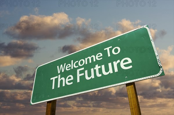 Welcome to the future green road sign with dramatic clouds and sky