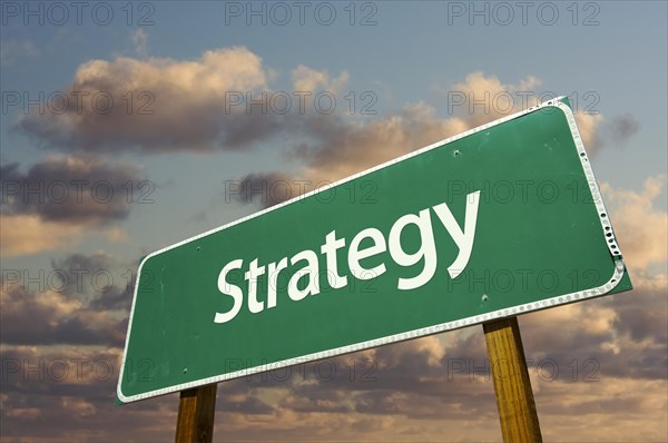 Strategy green road sign with dramatic blue sky and clouds