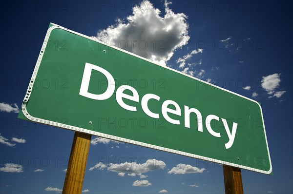 Decency road sign with dramatic clouds and sky