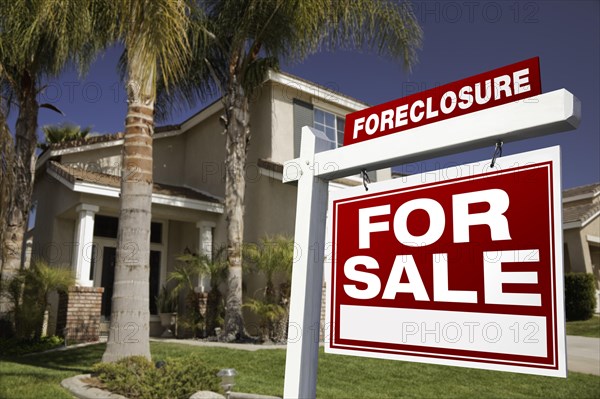 Foreclosure for sale real estate sign in front of house