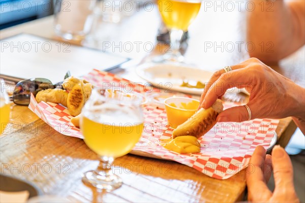 Woman enjoys warm pretzels and micro brew beer