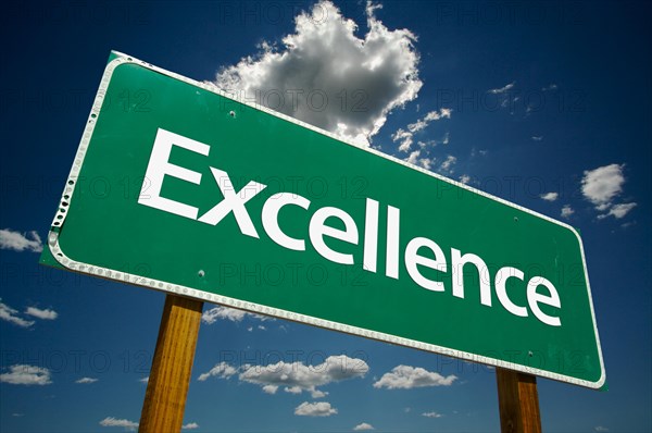 Excellence road sign with dramatic clouds and sky