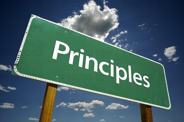 Principles road sign with dramatic clouds and sky