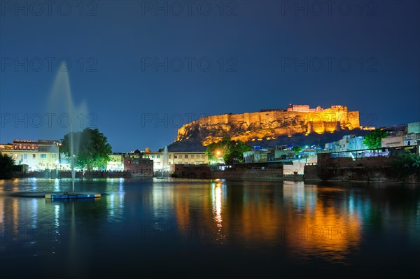 Famous indian tourist landmark Mehrangarh fort in the evening view over Gulab Sagar lake. Jodhpur