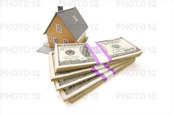 Home and stacks of money isolated on a white background