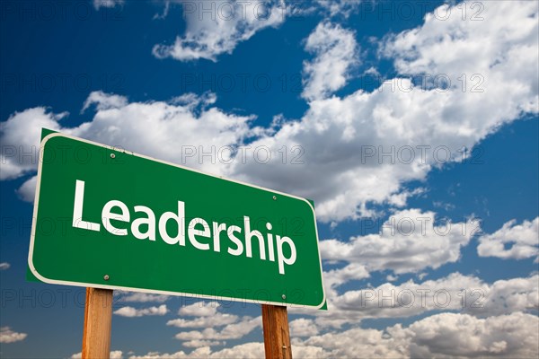 Leadership green road sign with copy room over the dramatic clouds and sky