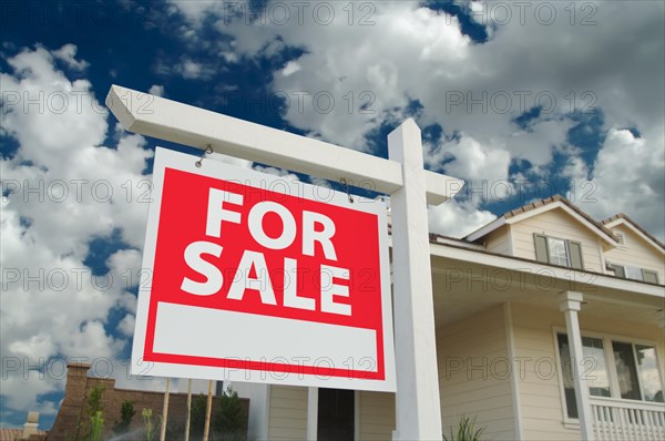 Home for sale sign in front of new house