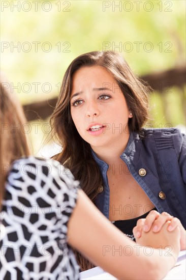 Concerned young adult woman talking with her friend