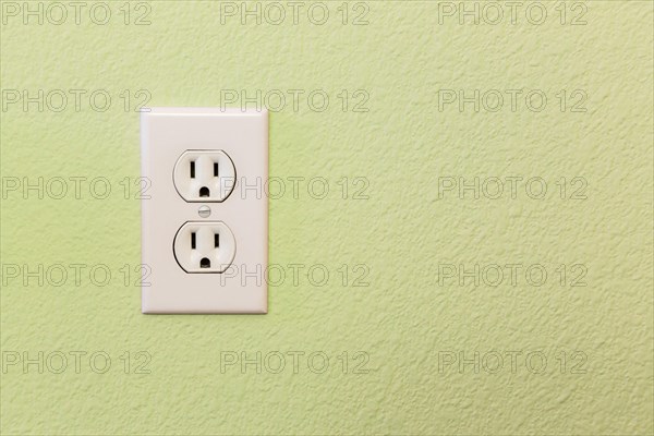 Electrical sockets in colorful wall of house