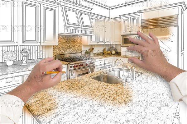 Male hands sketching with pencil A custom kitchen with photo showing through