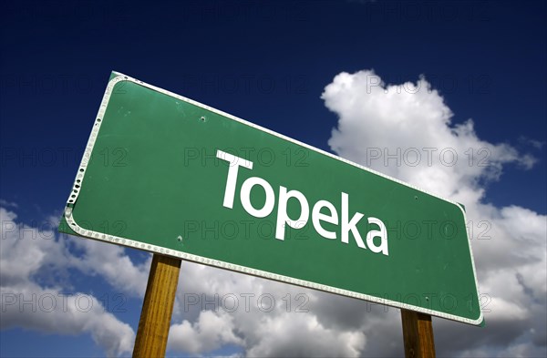 Topeka road sign with dramatic blue sky and clouds