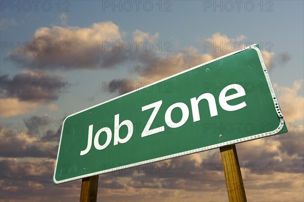 Job zone green road sign over dramatic clouds and sky