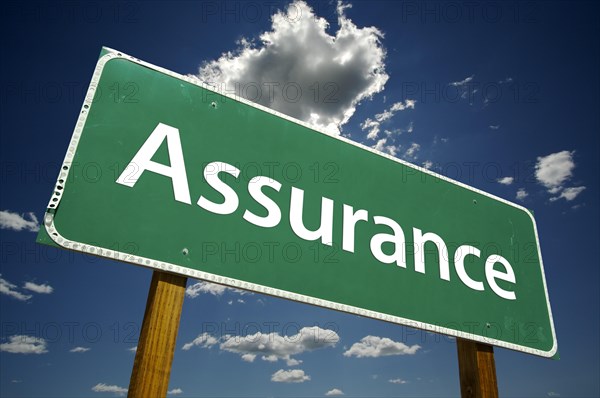 Assurance road sign with dramatic clouds and sky