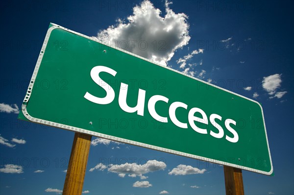 Success road sign with dramatic clouds and sky