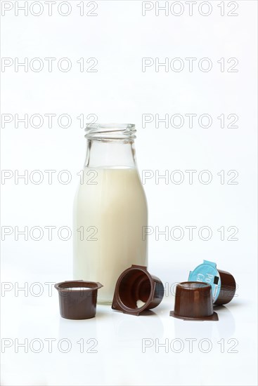 A bottle of milk and milk in portion pack