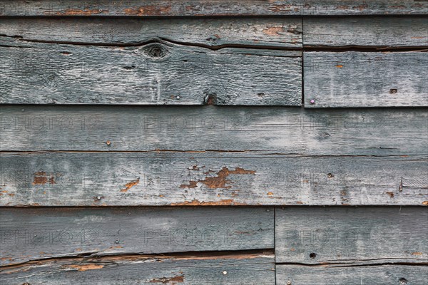 Weathered wood panel wall with peeling paint textured background