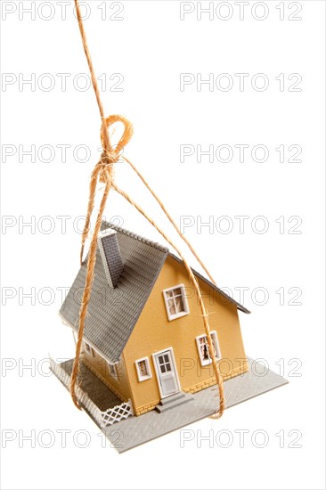 House hanging by a string isolated on a white background