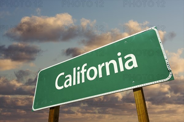 California green road sign with dramatic blue sky and clouds