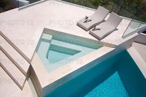 Custom luxury pool and chairs abstract with two jrts relaxing