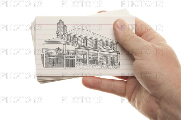 Male hand holding stack of flash cards with house drawing isolated on a white background
