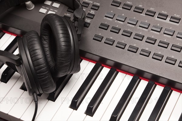 Headphones laying on electronic keyboard with narrow depth of fiel