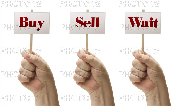 Three signs in male fists saying buy