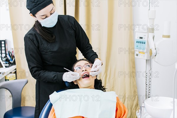 Dentist performing dental checkup