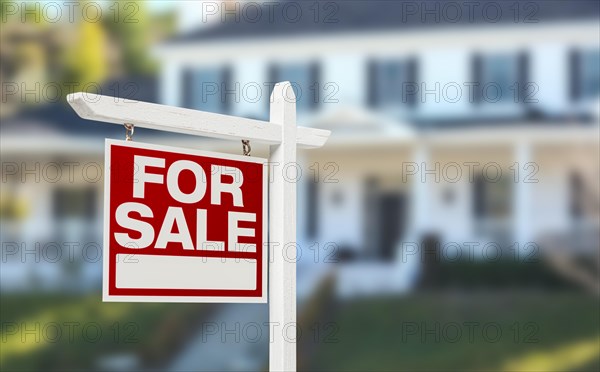 Home for sale real estate sign in front of beautiful new house