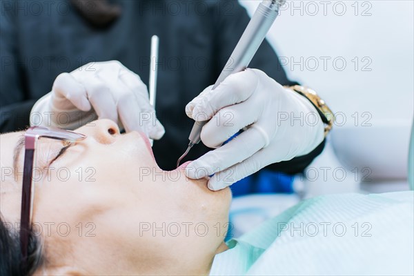 Close up o patient checked by dentist