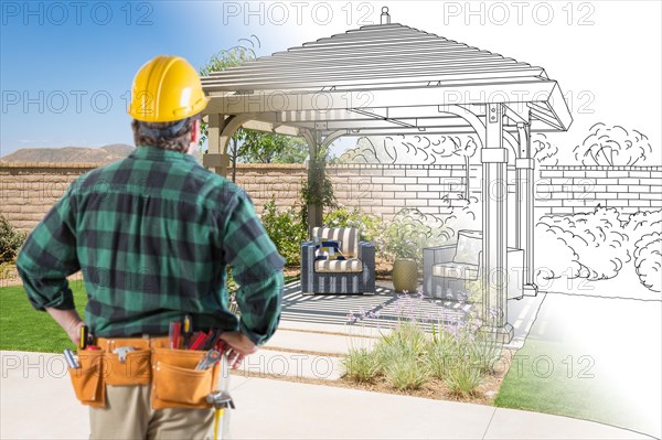 Contractor standing looking at patio pergola design drawing and photo combination