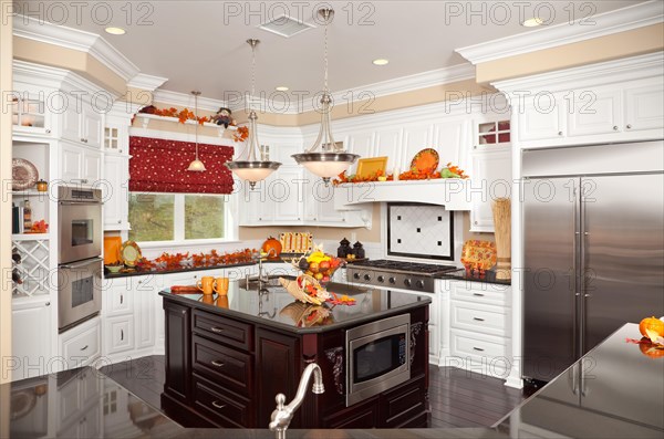 Beautiful custom kitchen interior with fall decorations in a new house