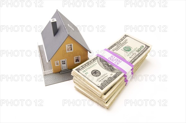 Home and stacks of money isolated on a white background