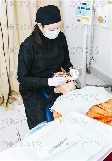 Dentist with patient lying down