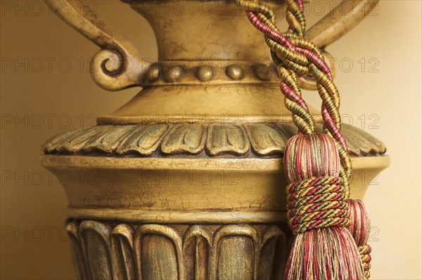 Lamp on table with ornate hanging tassel