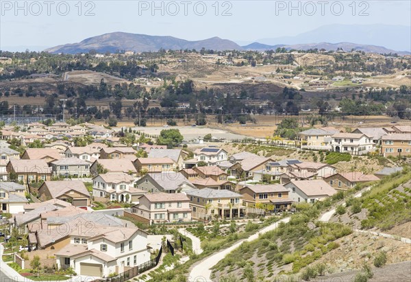 Elevated view of new contemporary suburban neighborhood and majestic clouds