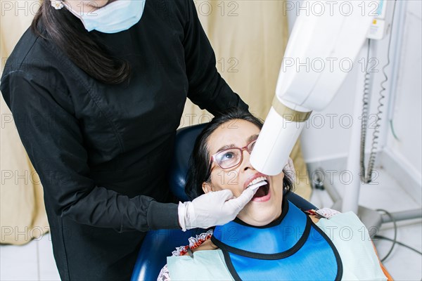 Female dentist doing dental x-ray