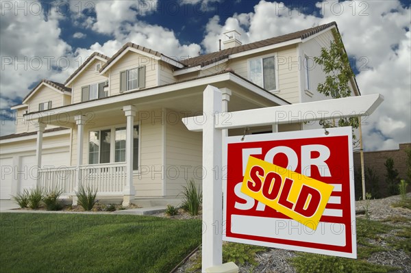 Sold home for sale sign in front of new house