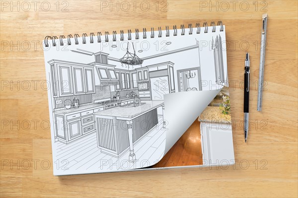 Sketch pad on desk with drawing of custom kitchen and page corner turning to show finished construction next to engineering pencil and ruler scale