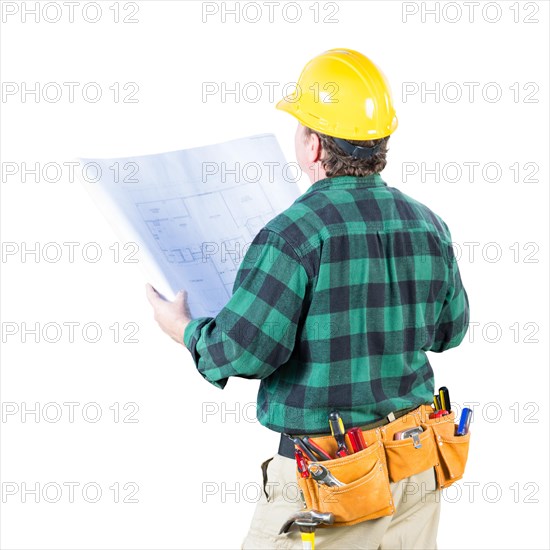 Male contractor with hard hat and tool belt looking away isolated a a white background