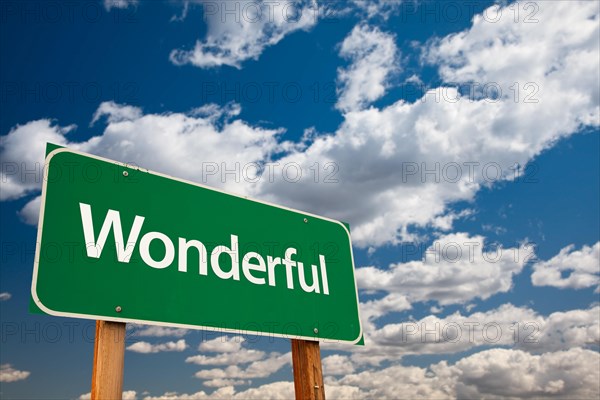 Wonderful green road sign with dramatic clouds and sky