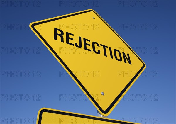 Rejection yellow road sign against a deep blue sky with clipping path