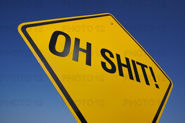 Yellow oh shit! road sign against A dramatic blue sky with clipping path