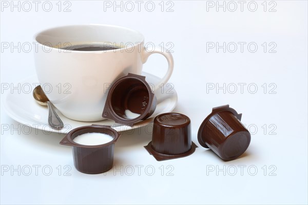 Cup of coffee and milk in portion pack