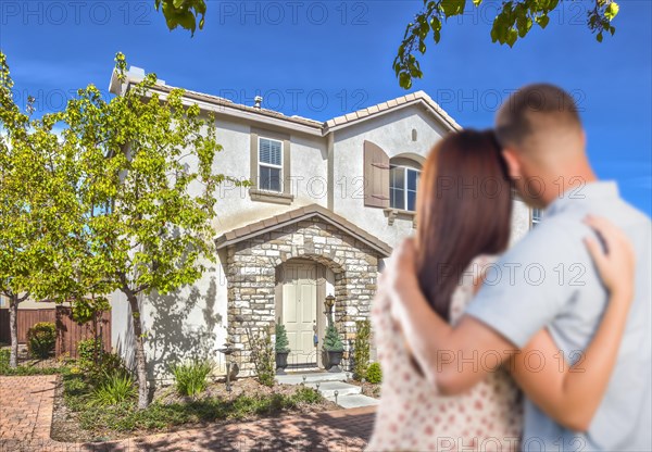 Affectionate military couple looking at nice new house