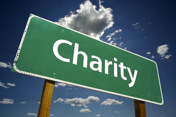 Charity road sign with dramatic blue sky and clouds