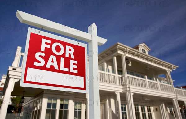 Home for sale sign in front of new house