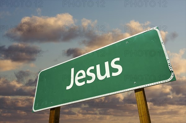 Jesus green road sign with dramatic blue sky and clouds