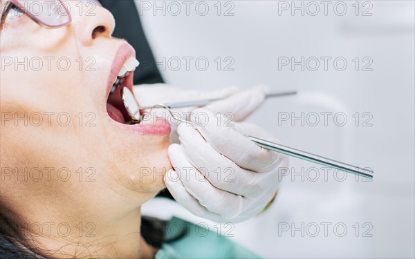 Dentist checking patient's mouth