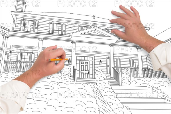 Male hands sketching with pencil the outline of a beautiful house on white