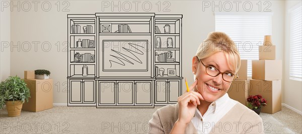 Woman inside room with moving boxes glancing toward entertainment unit drawing on wall